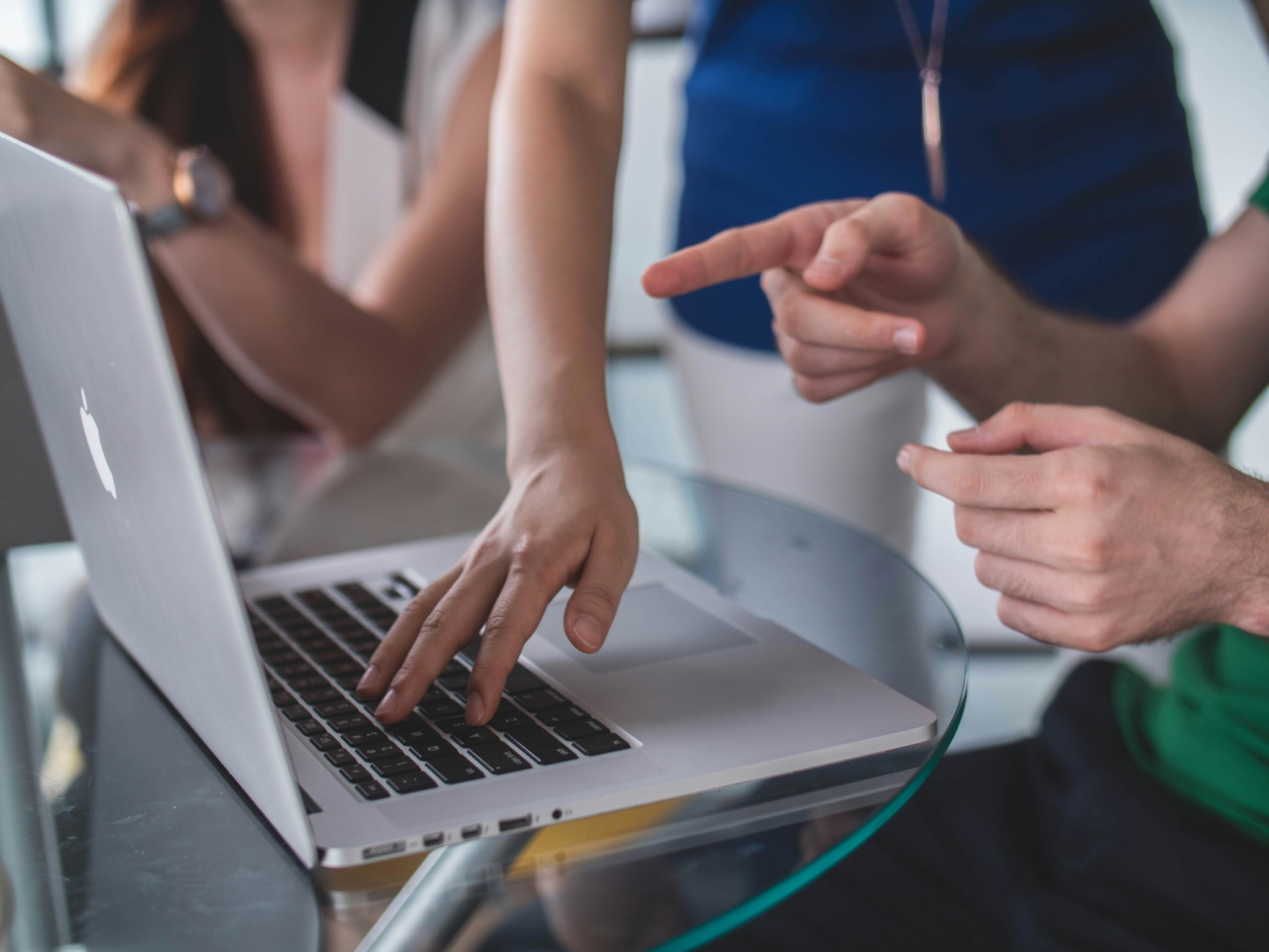 Professionals discussing a business requirement on a laptop